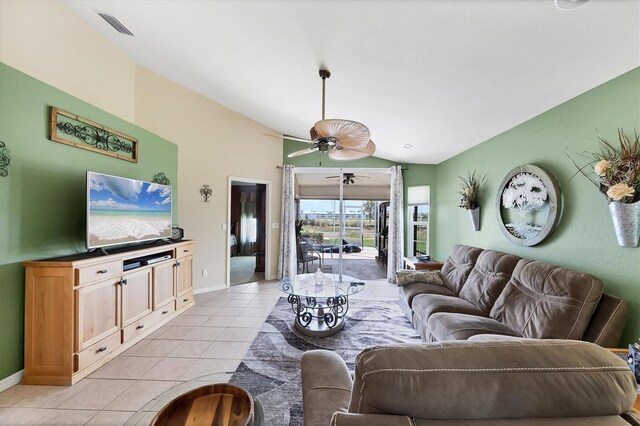 4225 Fairway Dr, North Port, FL 34287 - living area with lofted ceiling, light tile patterned floors, ceiling fan, and baseboards