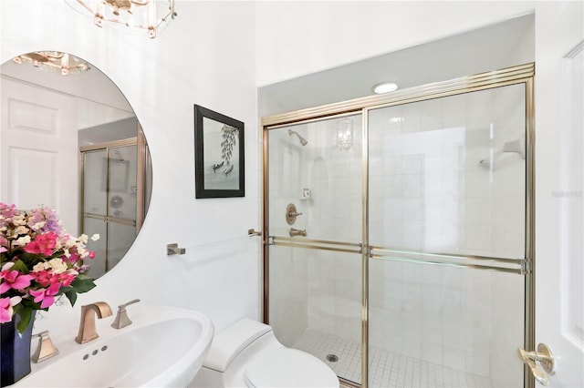 8500 Manasota Key Rd, Englewood, FL 34223 - full bathroom featuring a sink, a stall shower, and toilet