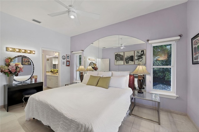 8500 Manasota Key Rd, Englewood, FL 34223 - bedroom featuring light tile patterned flooring, baseboards, ensuite bathroom, and ceiling fan