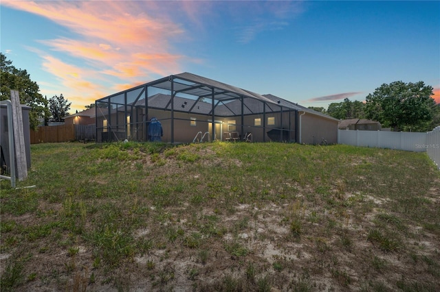 5510 Moongate Rd, Spring Hill, FL 34606 - back of property at dusk featuring glass enclosure