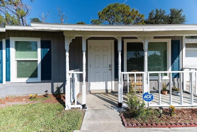 3261 Rogue St, North Port, FL 34291 - doorway to property with a porch and board and batten siding
