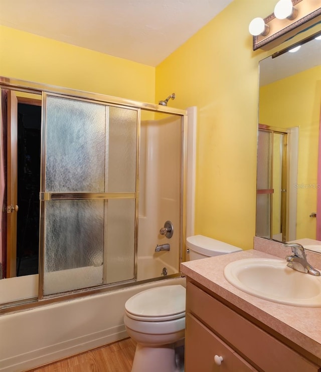 3261 Rogue St, North Port, FL 34291 - full bath with vanity, toilet, wood finished floors, and shower / bath combination with glass door