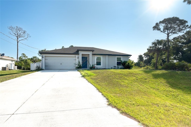 2408 Bonanza Ln, North Port, FL 34286 - view of front facade featuring driveway, an attached garage, a front yard, and stucco siding