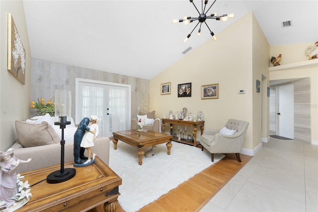 209 Fairway Rd, Rotonda West, FL 33947 - living room with a chandelier, french doors, baseboards, lofted ceiling, and an accent wall