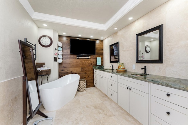 209 Fairway Rd, Rotonda West, FL 33947 - bathroom with ornamental molding, double vanity, a soaking tub, recessed lighting, and wooden walls