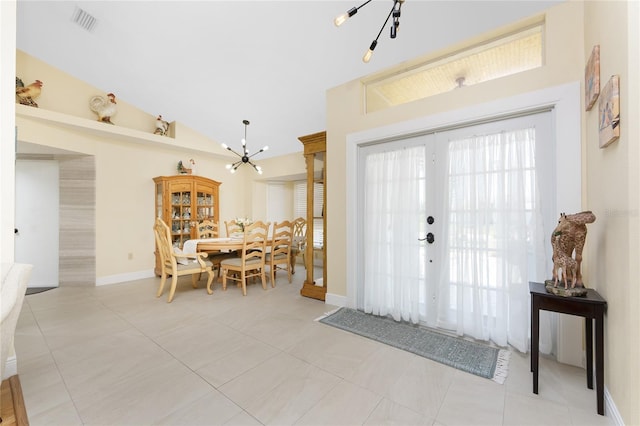209 Fairway Rd, Rotonda West, FL 33947 - foyer entrance featuring a chandelier, light tile patterned flooring, and high vaulted ceiling