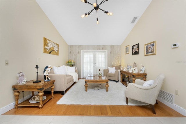 209 Fairway Rd, Rotonda West, FL 33947 - living area with wood finished floors, vaulted ceiling, baseboards, a chandelier, and french doors