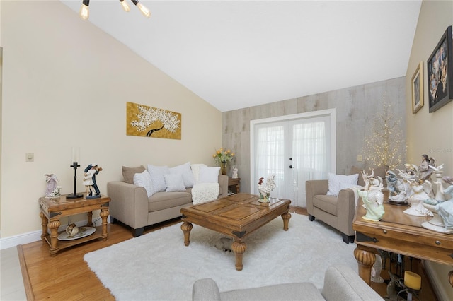 209 Fairway Rd, Rotonda West, FL 33947 - living room featuring lofted ceiling, wood finished floors, baseboards, and french doors