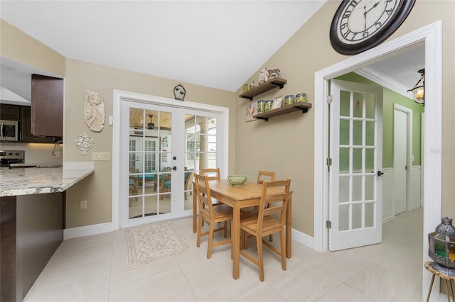 209 Fairway Rd, Rotonda West, FL 33947 - dining area with french doors, baseboards, light tile patterned floors, and lofted ceiling