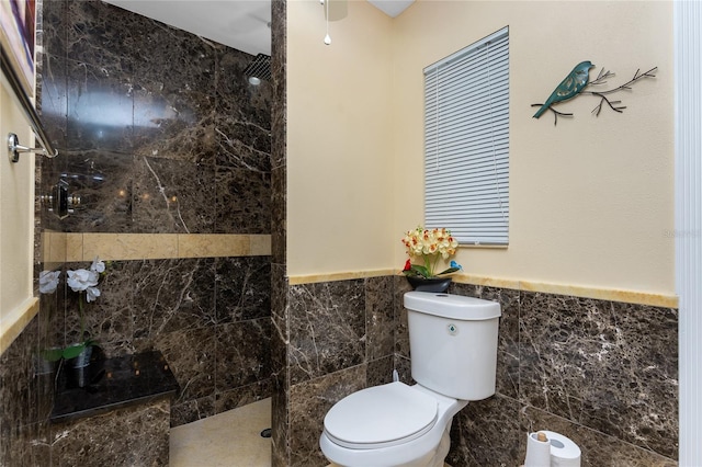 209 Fairway Rd, Rotonda West, FL 33947 - full bath featuring tile walls, toilet, a walk in shower, and a wainscoted wall