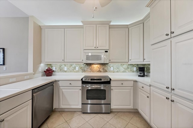 11100 Hacienda Del Mar Blvd Unit G-304, Placida, FL 33946 - kitchen featuring stainless steel appliances, light countertops, light tile patterned flooring, and a ceiling fan