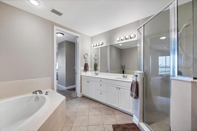 11100 Hacienda Del Mar Blvd Unit G-304, Placida, FL 33946 - full bath featuring double vanity, a garden tub, a stall shower, tile patterned flooring, and baseboards