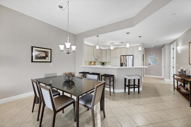 11100 Hacienda Del Mar Blvd Unit G-304, Placida, FL 33946 - dining room with light tile patterned floors, baseboards, and a chandelier