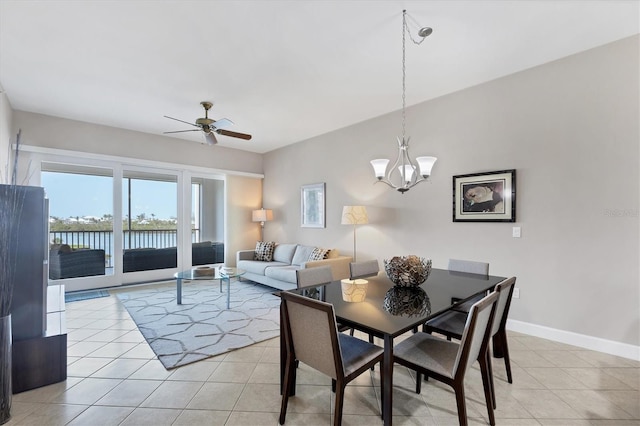 11100 Hacienda Del Mar Blvd Unit G-304, Placida, FL 33946 - dining area featuring a ceiling fan, light tile patterned floors, a chandelier, baseboards, and a water view