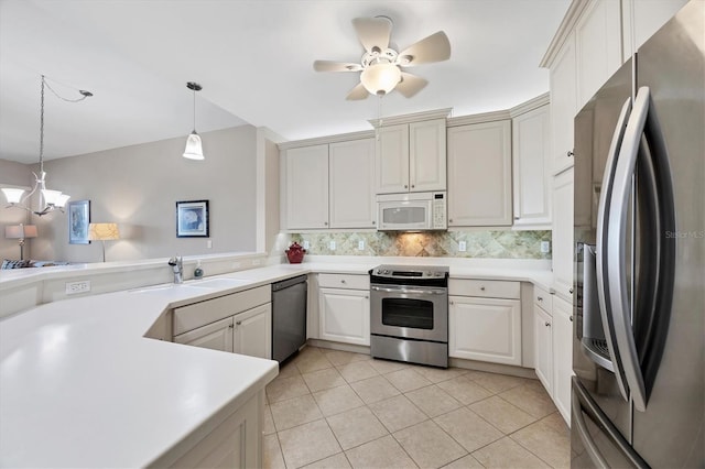 11100 Hacienda Del Mar Blvd Unit G-304, Placida, FL 33946 - kitchen featuring appliances with stainless steel finishes, light countertops, a sink, and decorative light fixtures