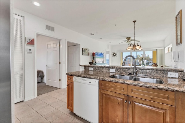 8411 Placida Rd Unit 404, Placida, FL 33946 - kitchen with dishwasher, brown cabinetry, a sink, light tile patterned floors, and recessed lighting