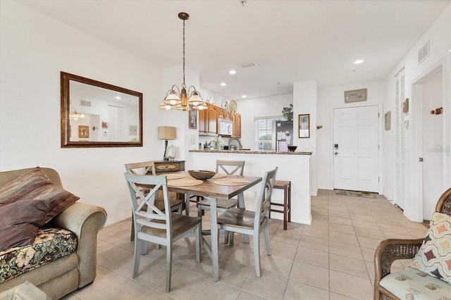 8411 Placida Rd Unit 404, Placida, FL 33946 - dining area with a chandelier, light tile patterned floors, recessed lighting, and baseboards