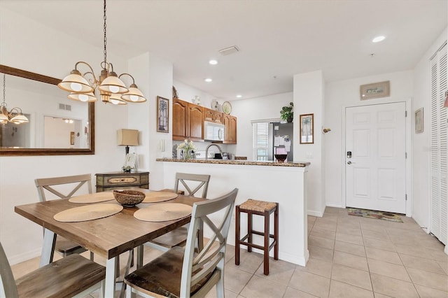 8411 Placida Rd Unit 404, Placida, FL 33946 - dining space featuring a chandelier, light tile patterned flooring, recessed lighting, and baseboards