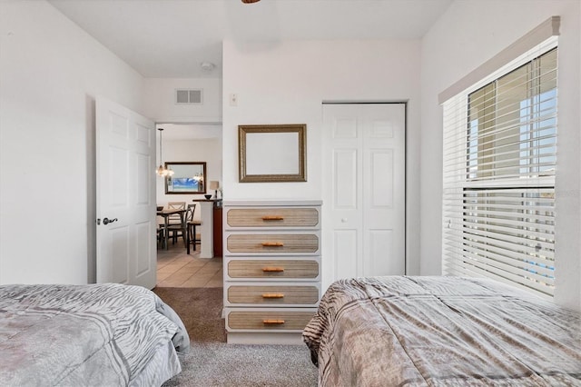 8411 Placida Rd Unit 404, Placida, FL 33946 - carpeted bedroom featuring multiple windows, a closet, and tile patterned flooring