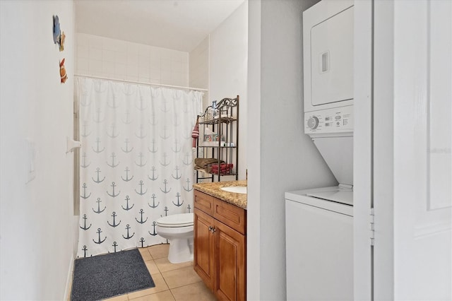 8411 Placida Rd Unit 404, Placida, FL 33946 - bathroom featuring stacked washing machine and dryer, tile patterned floors, toilet, and vanity