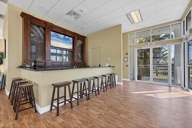 8411 Placida Rd Unit 404, Placida, FL 33946 - bar featuring baseboards, wood finished floors, and a high ceiling