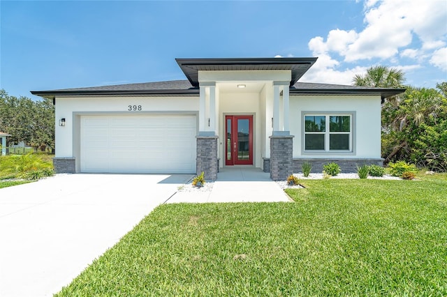 398 Sunset Rd N, Rotonda West, FL 33947 - prairie-style house featuring stucco siding, an attached garage, a front lawn, and concrete driveway