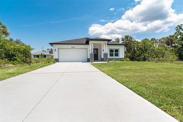 398 Sunset Rd N, Rotonda West, FL 33947 - prairie-style house with stucco siding, a garage, a front yard, driveway, and stone siding