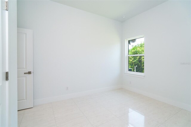 398 Sunset Rd N, Rotonda West, FL 33947 - empty room with baseboards and light tile patterned floors