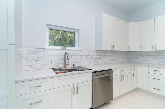 398 Sunset Rd N, Rotonda West, FL 33947 - kitchen with dishwasher, a sink, light stone countertops, white cabinets, and decorative backsplash