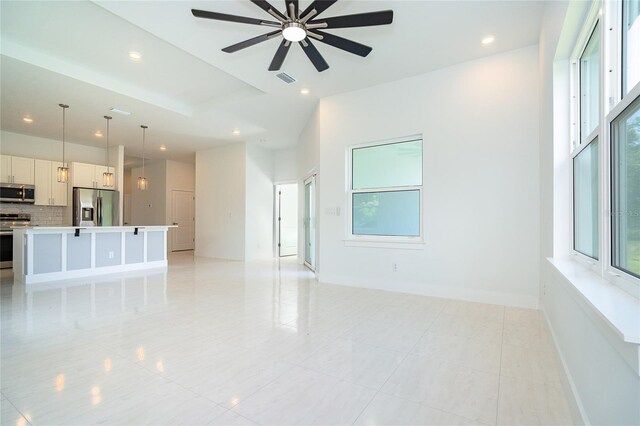 398 Sunset Rd N, Rotonda West, FL 33947 - unfurnished living room featuring ceiling fan, recessed lighting, light tile patterned floors, and baseboards