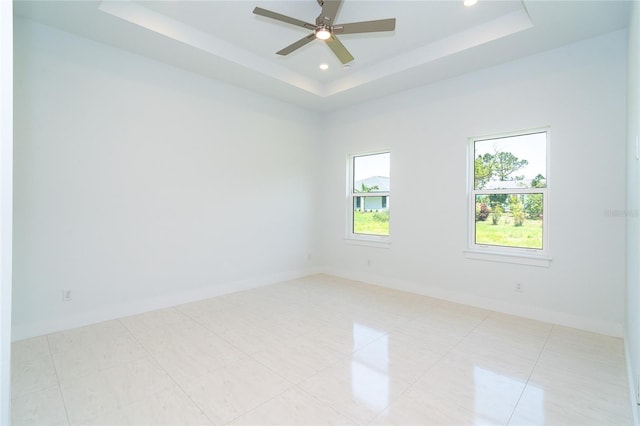 398 Sunset Rd N, Rotonda West, FL 33947 - unfurnished room featuring a tray ceiling, recessed lighting, ceiling fan, and baseboards