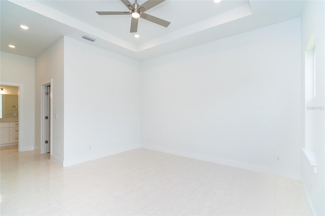 398 Sunset Rd N, Rotonda West, FL 33947 - empty room featuring a tray ceiling, a ceiling fan, baseboards, and recessed lighting