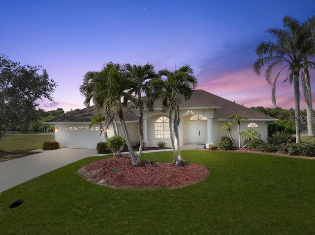 2295 Chilcote Ter, Port Charlotte, FL 33981 - single story home with driveway, a yard, stucco siding, roof with shingles, and a garage