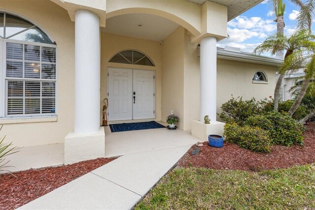 2295 Chilcote Ter, Port Charlotte, FL 33981 - doorway to property featuring stucco siding