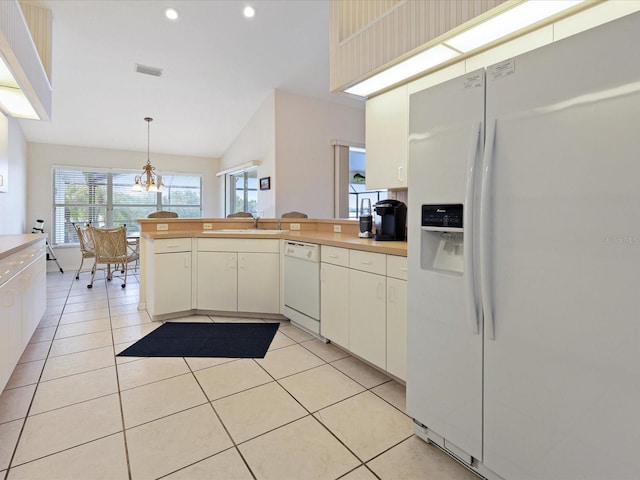 2295 Chilcote Ter, Port Charlotte, FL 33981 - kitchen featuring white appliances, a peninsula, plenty of natural light, a sink, and recessed lighting