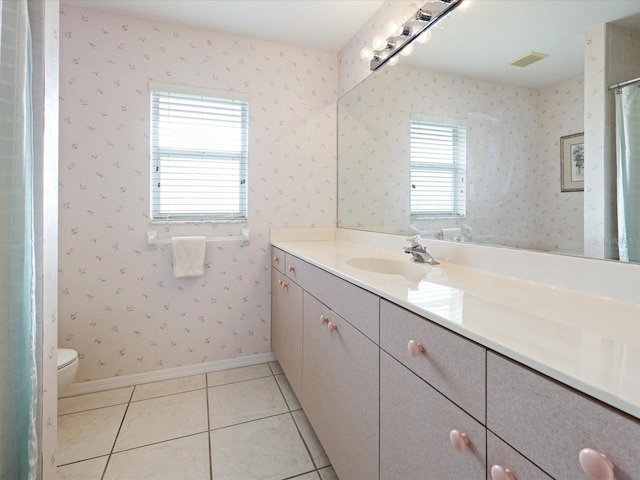 2295 Chilcote Ter, Port Charlotte, FL 33981 - bathroom with vanity, toilet, tile patterned flooring, baseboards, and wallpapered walls