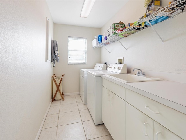 2295 Chilcote Ter, Port Charlotte, FL 33981 - laundry room with washer and clothes dryer, baseboards, light tile patterned floors, and cabinet space