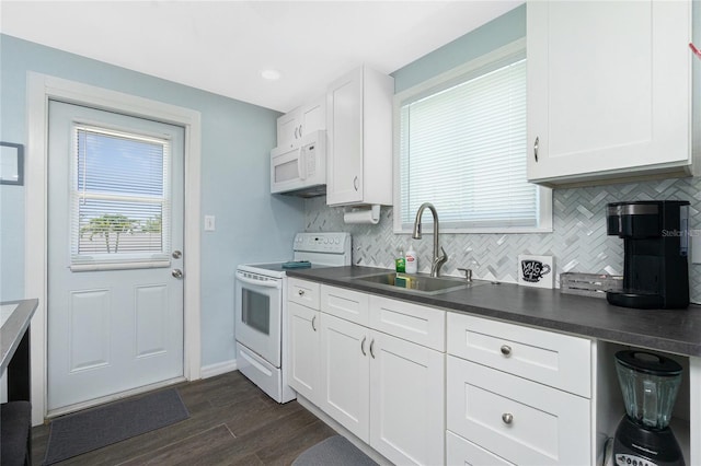 859 E 2nd St, Englewood, FL 34223 - kitchen with white appliances, a sink, decorative backsplash, dark countertops, and dark wood-style floors