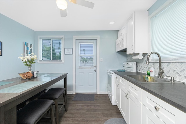 859 E 2nd St, Englewood, FL 34223 - kitchen featuring white appliances, a sink, dark wood finished floors, dark countertops, and tasteful backsplash