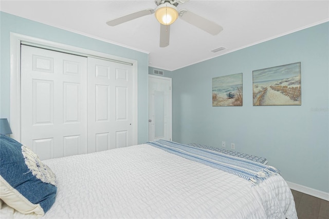 859 E 2nd St, Englewood, FL 34223 - bedroom featuring a closet, baseboards, ornamental molding, a ceiling fan, and wood finished floors