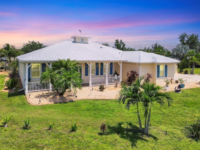 8127 Consul St, Port Charlotte, FL 33981 - back of property at dusk with a porch and a yard