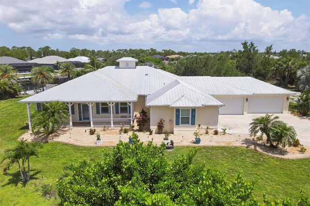 8127 Consul St, Port Charlotte, FL 33981 - rear view of house with a porch, driveway, a garage, and a yard