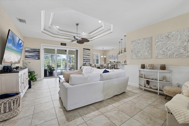 8127 Consul St, Port Charlotte, FL 33981 - living area featuring a ceiling fan, a wainscoted wall, a raised ceiling, and recessed lighting