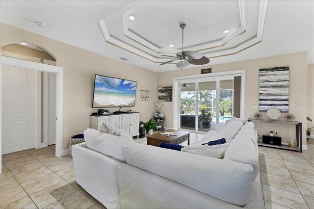 8127 Consul St, Port Charlotte, FL 33981 - living room with a tray ceiling, ceiling fan, recessed lighting, and light tile patterned floors