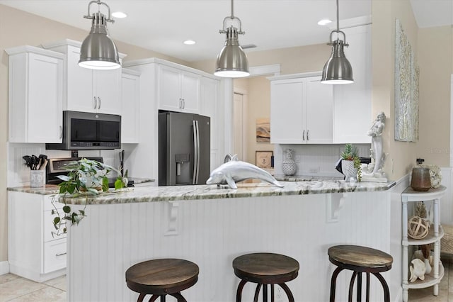 8127 Consul St, Port Charlotte, FL 33981 - kitchen with stainless steel appliances, a peninsula, white cabinetry, and recessed lighting