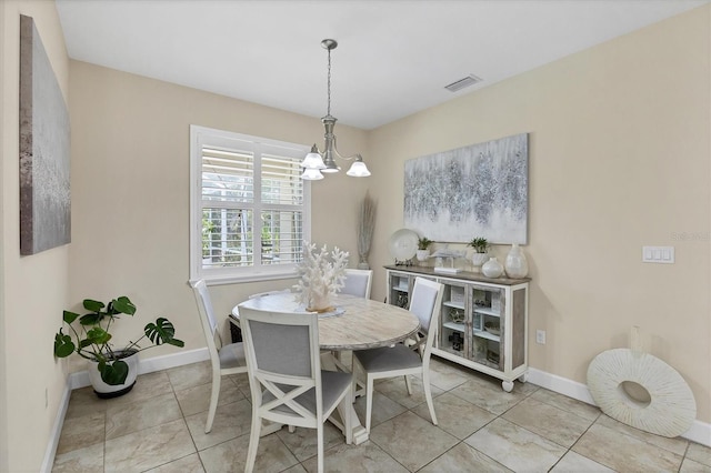 8127 Consul St, Port Charlotte, FL 33981 - tiled dining area with a chandelier and baseboards