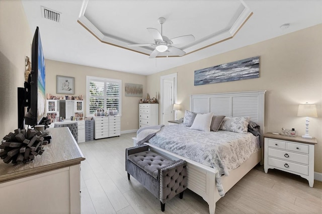 8127 Consul St, Port Charlotte, FL 33981 - bedroom featuring a raised ceiling, light wood finished floors, and a ceiling fan