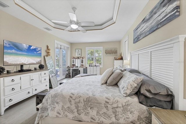 8127 Consul St, Port Charlotte, FL 33981 - bedroom featuring a raised ceiling, access to outside, wood finished floors, and a ceiling fan