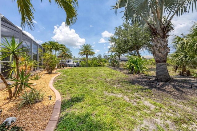 8127 Consul St, Port Charlotte, FL 33981 - view of grassy yard featuring glass enclosure