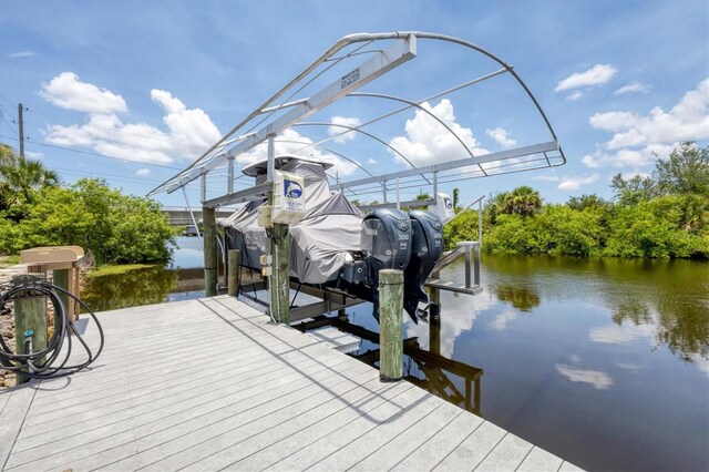 8127 Consul St, Port Charlotte, FL 33981 - dock area featuring boat lift and a water view